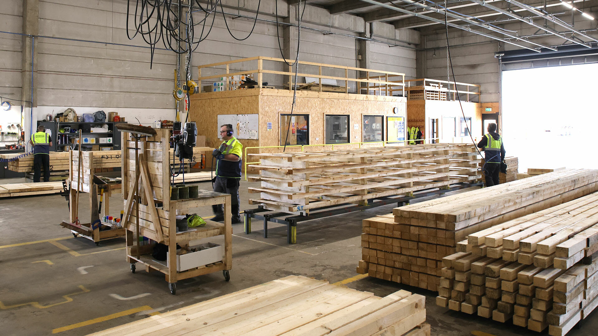 factory workers assembling wooden custom size pallet